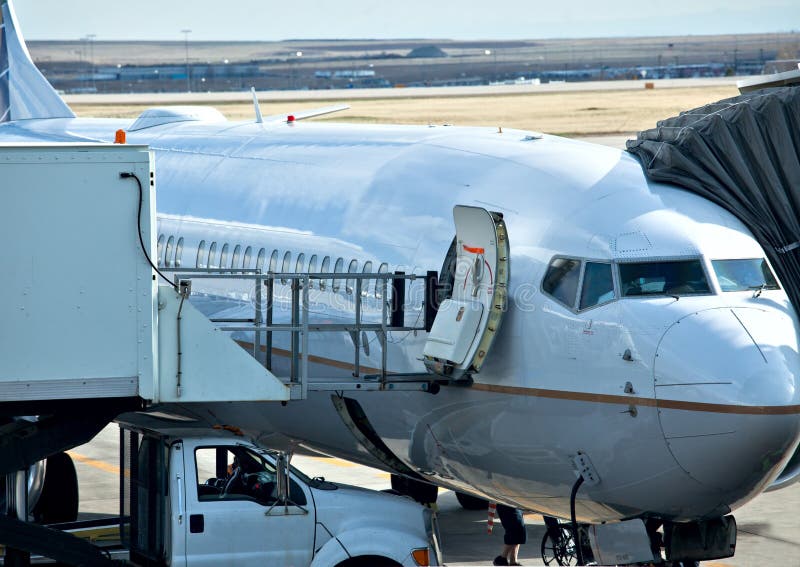 Unloading/loading a plane at the airport. Unloading/loading a plane at the airport.