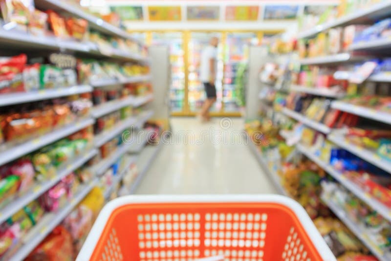 Shopping cart with Supermarket convenience store aisle shelves interior blur for background. Shopping cart with Supermarket convenience store aisle shelves interior blur for background