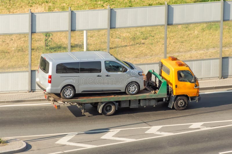 Carriage of a Small Minibus on the Platform Tow Truck Stock Image