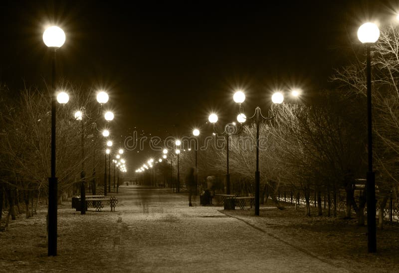 Night winter city lane with burning street lamps in sepia tone. Night winter city lane with burning street lamps in sepia tone