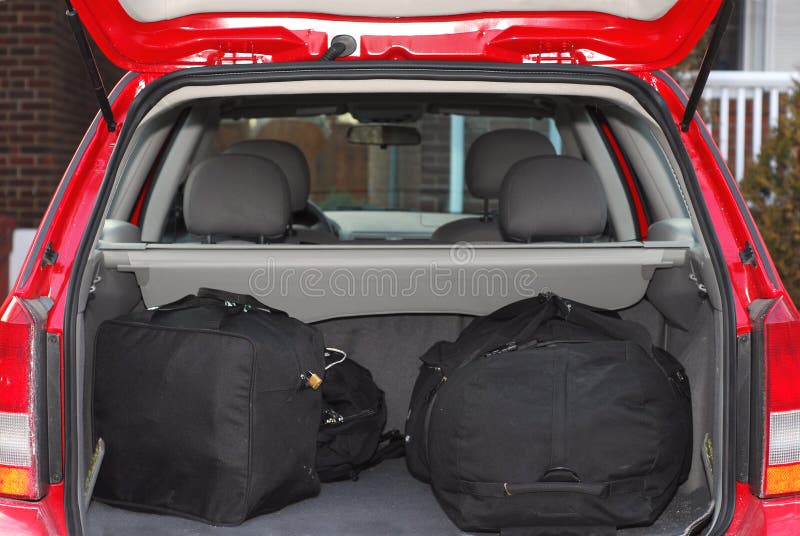 Red hatchback car loaded with open trunk and luggage. Red hatchback car loaded with open trunk and luggage