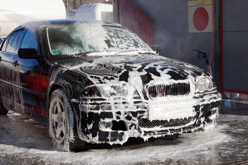 car in foam at a car wash close up. car in foam at a car wash close up