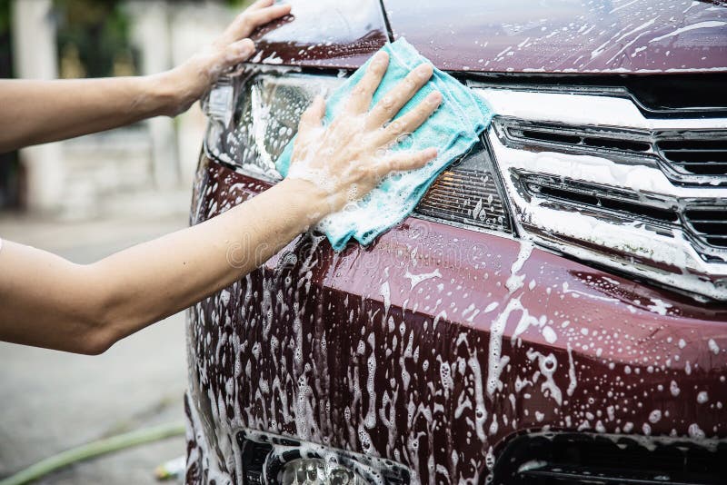 Man wash car using shampoo - every day life car care concept. Man wash car using shampoo - every day life car care concept