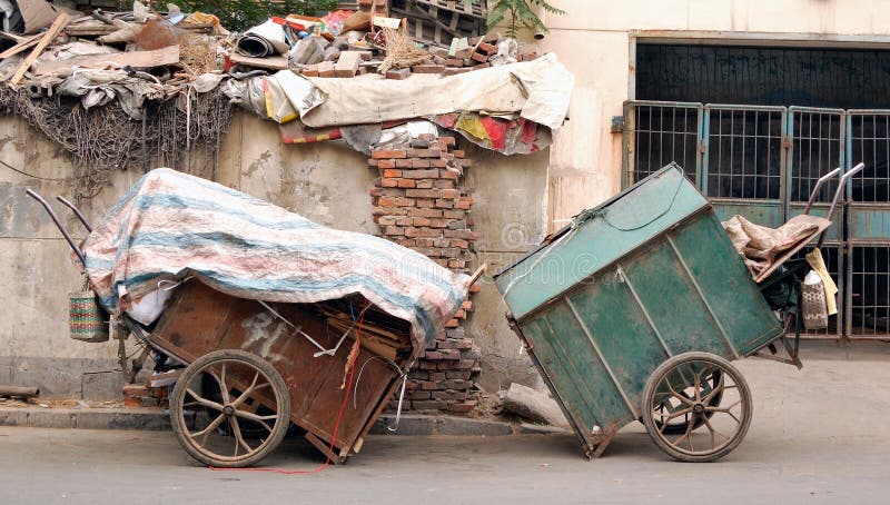 Two wheeled hand-driven garbage truck in asia city. Two wheeled hand-driven garbage truck in asia city