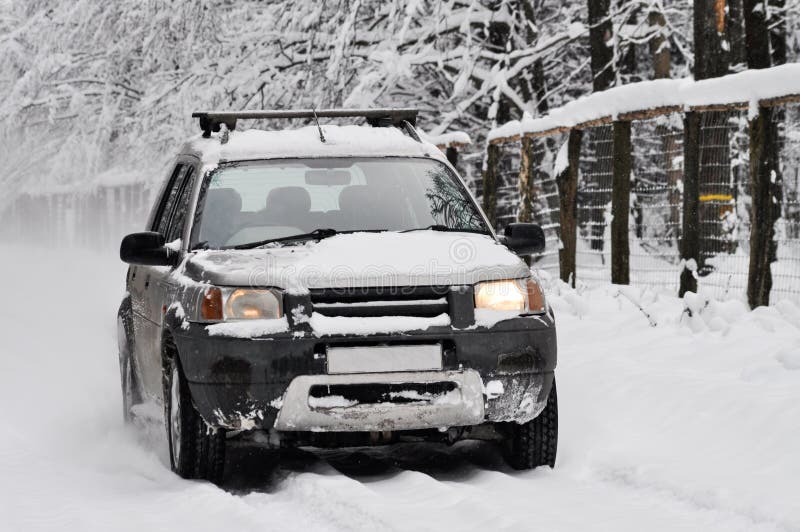 Off road jeep in middle of snowy road in winter. Off road jeep in middle of snowy road in winter.