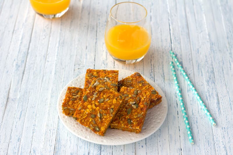 Carrot bars with oatmeal, dried apricots, seeds and honey with orange juice