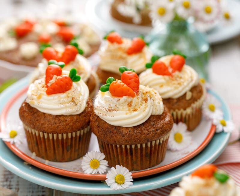 Carrot cake muffins with mascarpone cream,  topped with marzipan carrots.