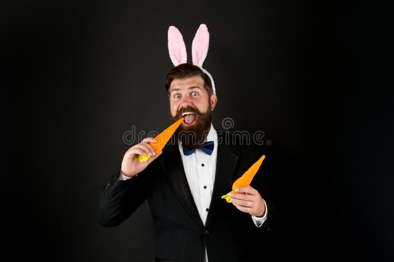Carrot is good for your teeth. Celebration Easter holiday. Easter day. Event host. Celebrate Easter. Bearded man with royalty free stock photos Carrot is good for your teeth. Celebration Easter holiday. Easter day. Event host. Celebrate Easter. Bearded man with royalty free stock photos