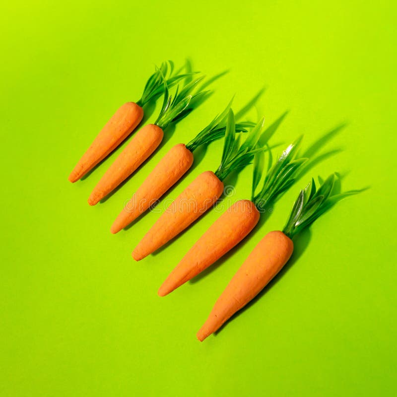 Carrots on pastel yellow. Minimal Easter concept. Spring minimal composition royalty free stock photos