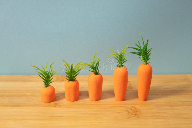 Carrots on wooden background. Minimal Easter concept. Spring minimal composition stock photography