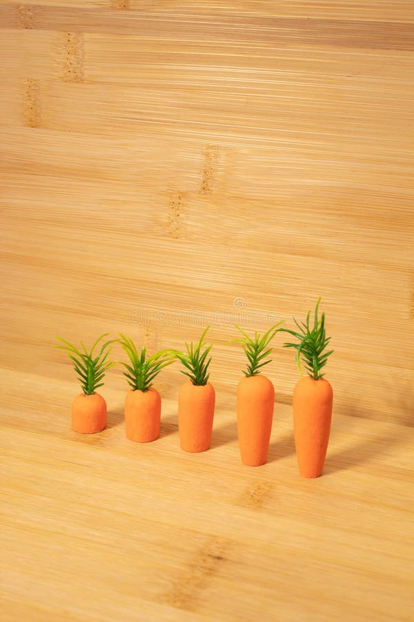 Carrots on wooden and blue background. Minimal Easter concept. Spring minimal composition royalty free stock photos
