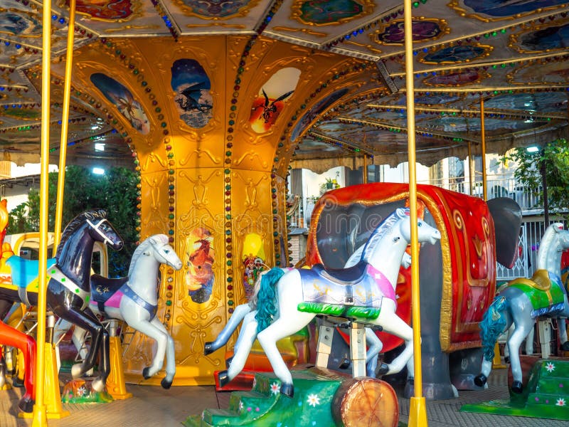 Carousel with horses. Bright attraction for children. Entertainment in the park. Toy horses. Driving in a circle. Entertainment industry concept. Carousel with horses. Bright attraction for children. Entertainment in the park. Toy horses. Driving in a circle. Entertainment industry concept