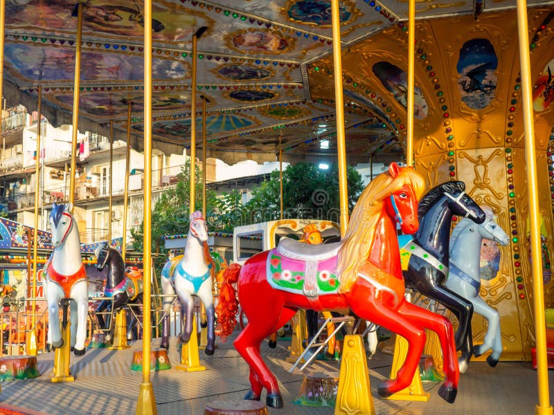 Carousel with horses. Bright attraction for children. Entertainment in the park. Toy horses. Driving in a circle. Entertainment industry concept. Carousel with horses. Bright attraction for children. Entertainment in the park. Toy horses. Driving in a circle. Entertainment industry concept