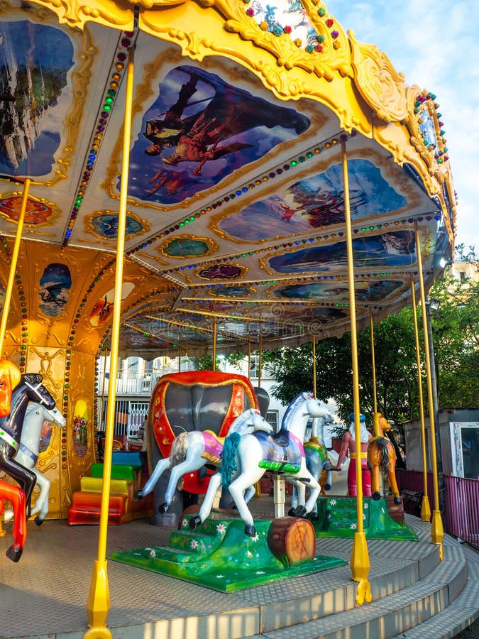 Carousel with horses. Bright attraction for children. Entertainment in the park. Toy horses. Driving in a circle. Entertainment industry concept. Carousel with horses. Bright attraction for children. Entertainment in the park. Toy horses. Driving in a circle. Entertainment industry concept