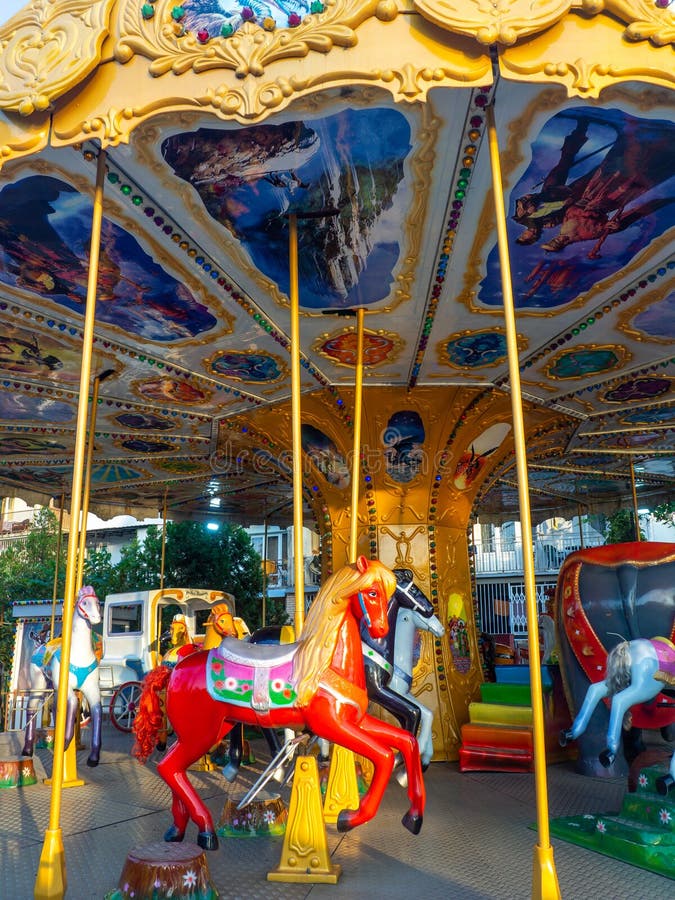 Carousel with horses. Bright attraction for children. Entertainment in the park. Toy horses. Driving in a circle. Entertainment industry concept. Carousel with horses. Bright attraction for children. Entertainment in the park. Toy horses. Driving in a circle. Entertainment industry concept
