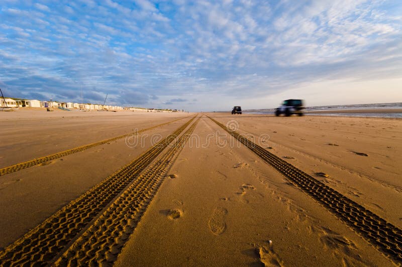 Cars driving on the beach stock photo. Image of rocks 2905272