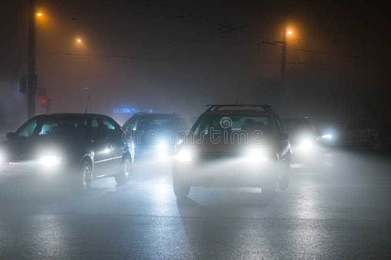 Cars driving in fog stock image. Image of night, city 41359709