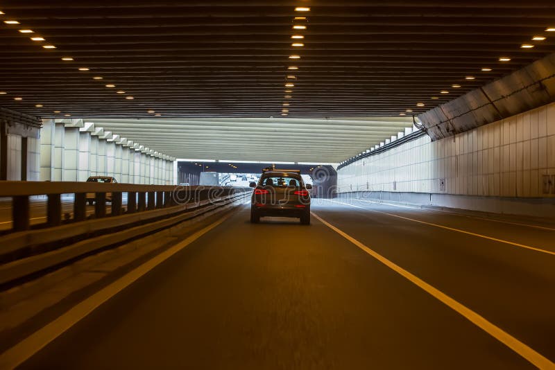 Cars Leaving Tunnel in Downtown Stock Photo - Image of light, land