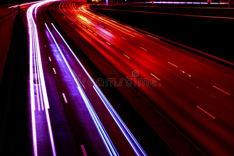 Cars Light Trails On A Curved Highway At Night. Night Traffic Trails. Motion Blur. Night City Road With Traffic Headlight Motion.