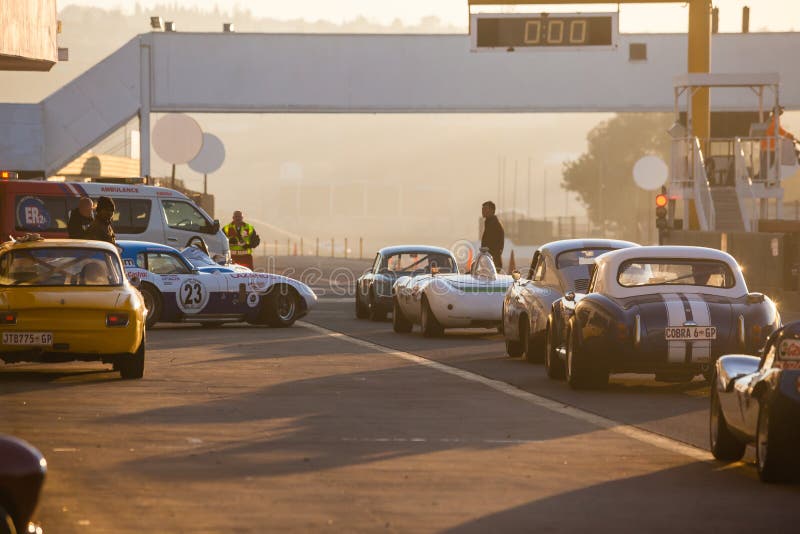 A historic car race held at the Kyalami racetrack in July 2014. Cars line up on the starting line at Kyalami race track on a cold winter morning. South Africa.