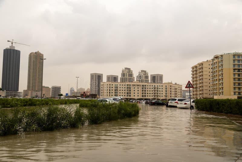DUBAI, UAE - CIRCA 2020: Cars stuck in water in a flooded parking lot after heavy in rain in Dubai stock photography DUBAI, UAE - CIRCA 2020: Cars stuck in water in a flooded parking lot after heavy in rain in Dubai stock photography