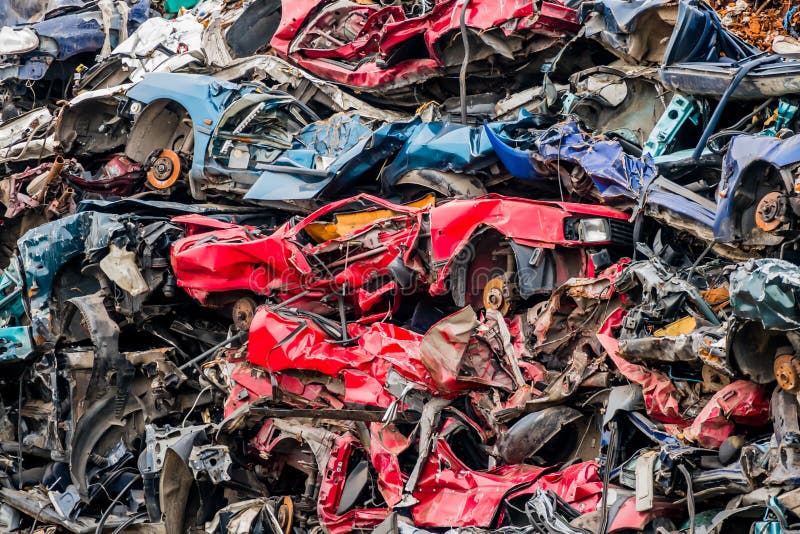 Old cars were scrapped in a trash compactor. scrap iron and scrapping premium for car wrecks