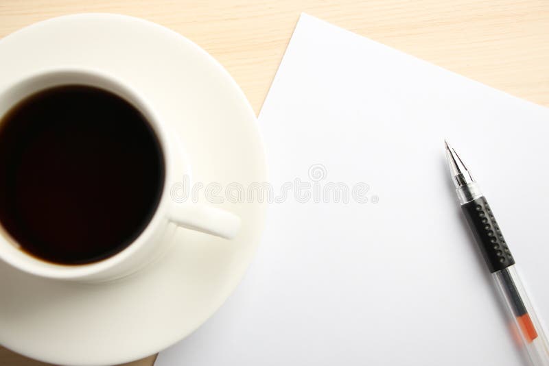 Blank white paper is on the table with ball pen and coffee aside. Blank white paper is on the table with ball pen and coffee aside.