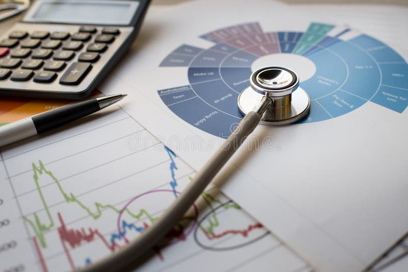 Medical practice financial analysis charts with stethoscope and calculator concept. Medical practice financial analysis charts with stethoscope and calculator concept