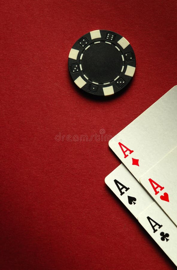 Card winning with a combination of aces four of a kind or quads on a red table in a poker club. Free space for advertising. Card winning with a combination of aces four of a kind or quads on a red table in a poker club. Free space for advertising.