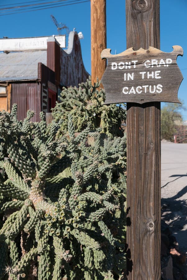 Sign on the street in Oatman, Arizona, Don`t crap in the cactus. Sign on the street in Oatman, Arizona, Don`t crap in the cactus