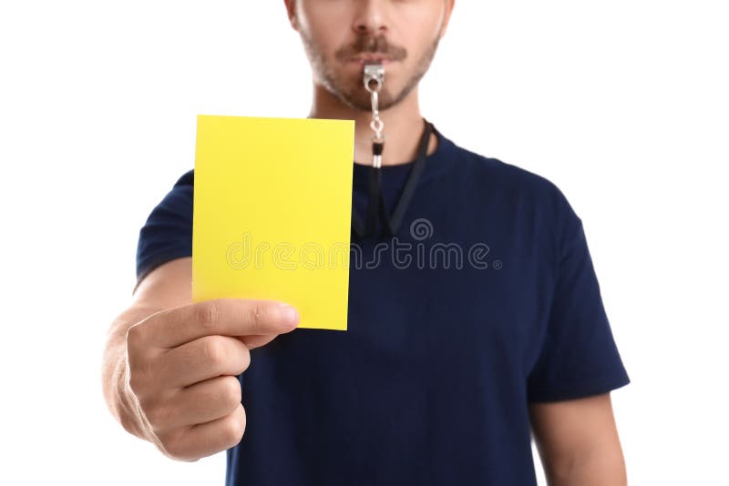 Cartellino giallo della tenuta dell'arbitro di calcio su fondo bianco fotografie stock Cartellino giallo della tenuta dell'arbitro di calcio su fondo bianco fotografie stock