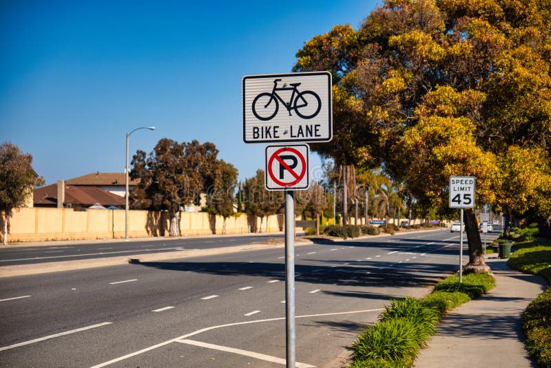 Oxnard, United States - February 20 2020 : a road sign is indicating a bike lane on the road and that parking is not allowed. Oxnard, United States - February 20 2020 : a road sign is indicating a bike lane on the road and that parking is not allowed