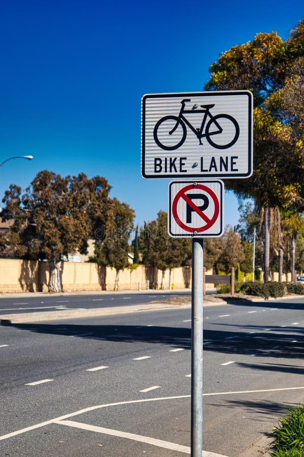 Oxnard, United States - February 20 : a road sign is indicating a bike lane on the road and that parking is not allowed. Oxnard, United States - February 20 : a road sign is indicating a bike lane on the road and that parking is not allowed