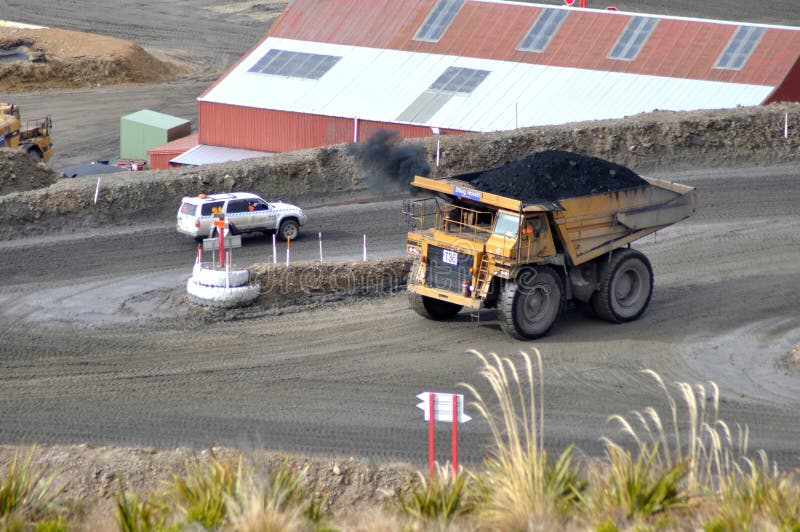 Carting the coal. WESTPORT, NEW ZEALAND, AUGUST 31, 2013: 70 ton truck passes a 4WD at Stockton open cast coal mine on August 31, 2013 near Westport, New Zealand stock photo Carting the coal. WESTPORT, NEW ZEALAND, AUGUST 31, 2013: 70 ton truck passes a 4WD at Stockton open cast coal mine on August 31, 2013 near Westport, New Zealand stock photo