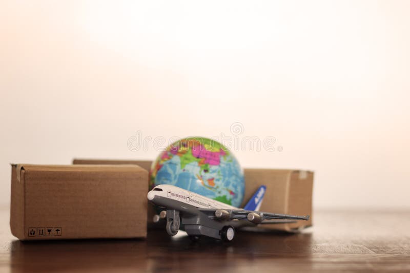 Cartons with airplane and earth globe. Global logistics, shipping and worldwide delivery business concept