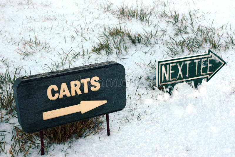 Carts and next tee sign on a snow golf course