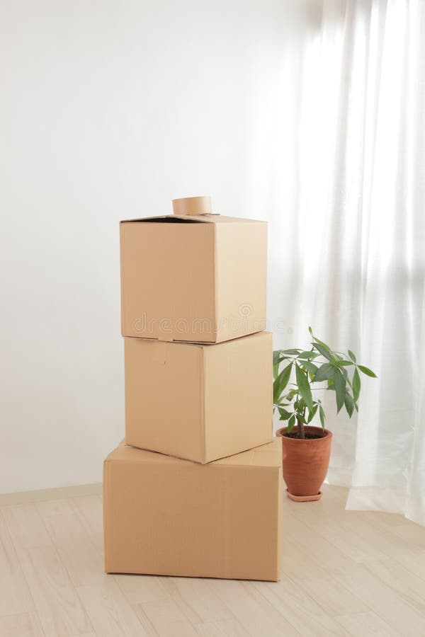 The cardboard boxes stacked in the room. The cardboard boxes stacked in the room