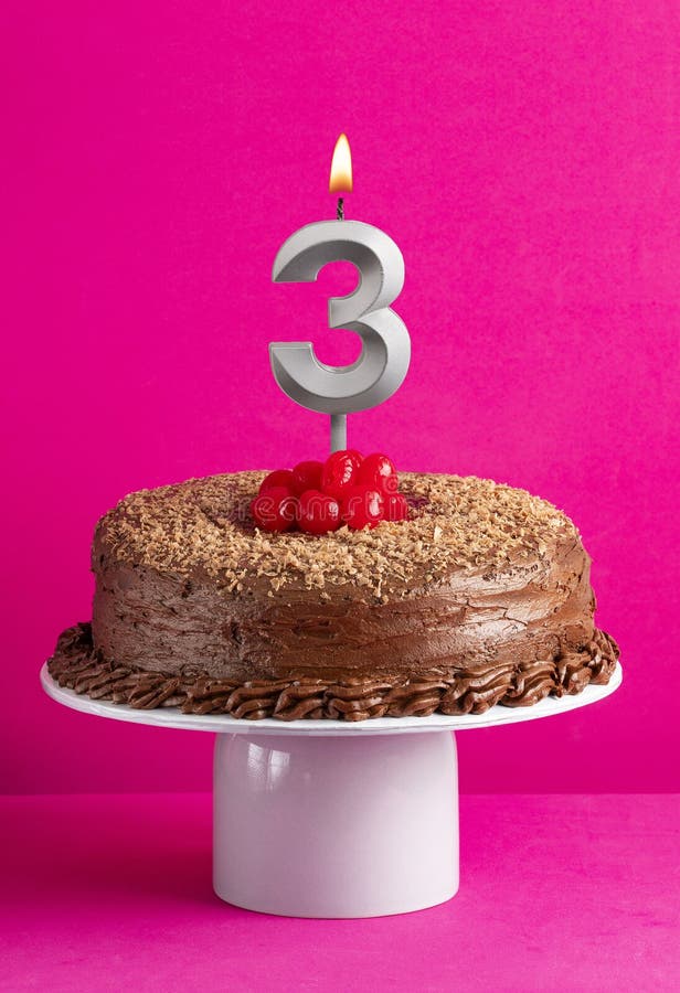 Number 3 candle - Chocolate cake on pink background. Number 3 candle - Chocolate cake on pink background