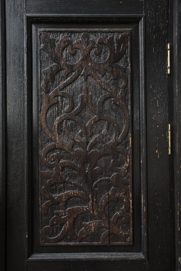 Carved panel of an old wooden door