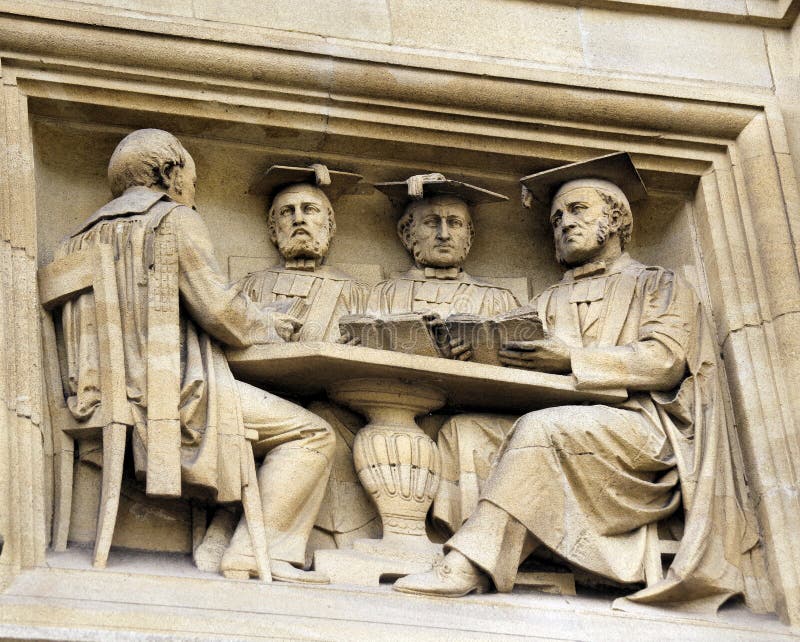 A Carving of Learned Gentlemen. On the front of the Oxford University Examination Schools Building, High Street, Oxford, England, UK royalty free stock photos A Carving of Learned Gentlemen. On the front of the Oxford University Examination Schools Building, High Street, Oxford, England, UK royalty free stock photos