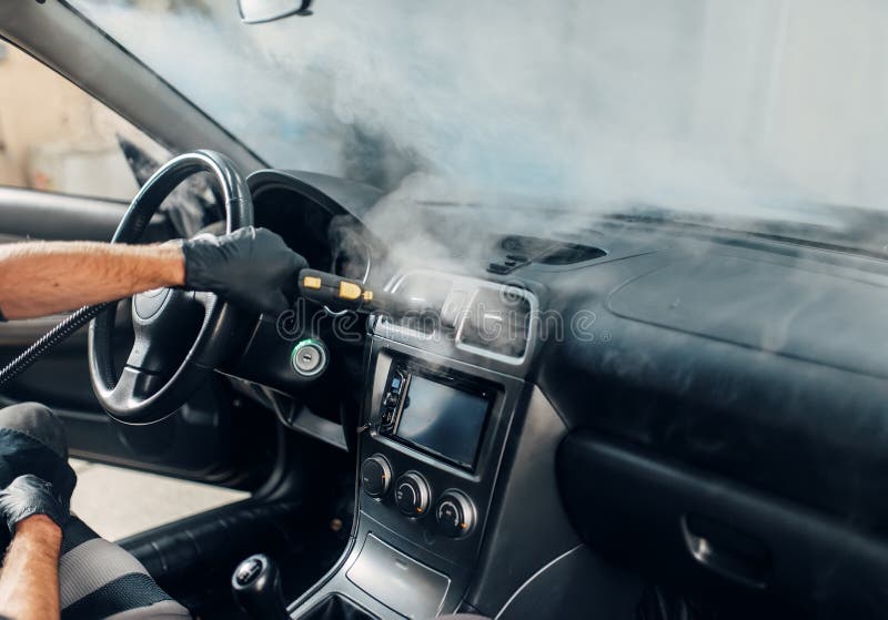 Carwash, Worker Cleans Salon with Steam Cleaner Stock Image