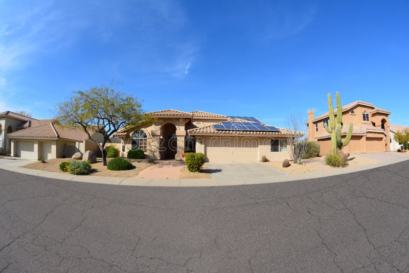 Single-family detached house with rooftop solar panels located on a beautiful suburban neighborhood street. Single-family detached house with rooftop solar panels located on a beautiful suburban neighborhood street