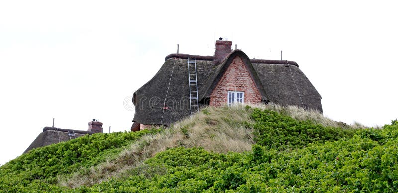 Casa com o telhado cobrido com sapê na ilha de Sylt, Alemanha foto de stock Casa com o telhado cobrido com sapê na ilha de Sylt, Alemanha foto de stock