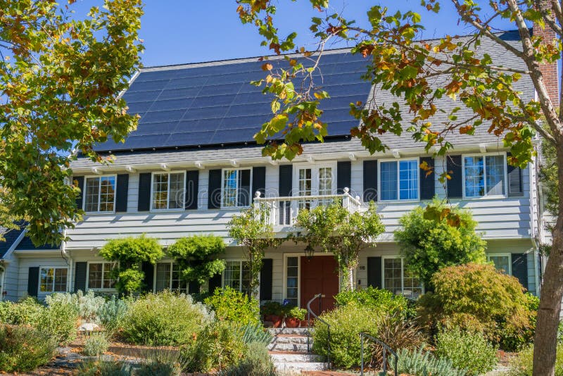 House with solar panels on the roof in a residential neighborhood of Oakland, in San Francisco bay on a sunny day, California. House with solar panels on the roof in a residential neighborhood of Oakland, in San Francisco bay on a sunny day, California