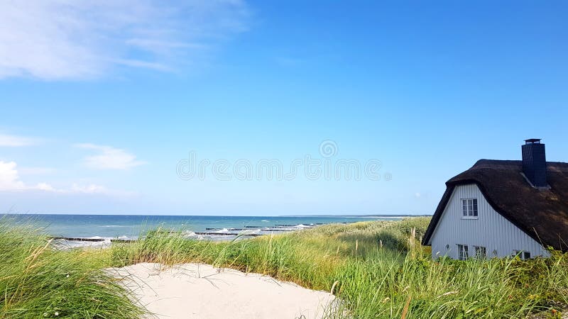 A casa com ree do telhado ou cobre com sapê na praia imagem de stock royalty free A casa com ree do telhado ou cobre com sapê na praia imagem de stock royalty free