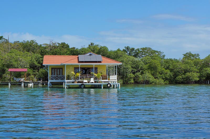 Off grid house over the sea with solar panels on the roof, Caribbean, Panama. Off grid house over the sea with solar panels on the roof, Caribbean, Panama