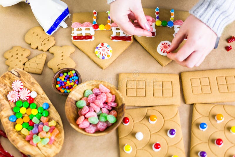 Decorating gingerbread house with royal icing and colorful candies. Decorating gingerbread house with royal icing and colorful candies.