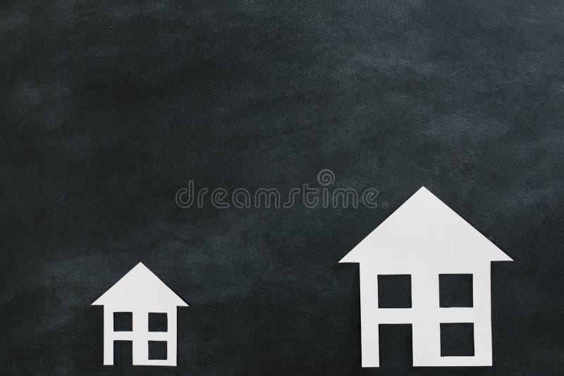 Paper house model isolated on blackboard background with high angle view photo. Paper house model isolated on blackboard background with high angle view photo.