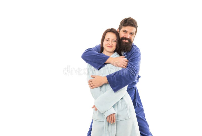 Couple in love in robes of happy guy hugging girl in morning isolated on white, lovers. Couple in love in robes of happy guy hugging girl in morning isolated on white, lovers.