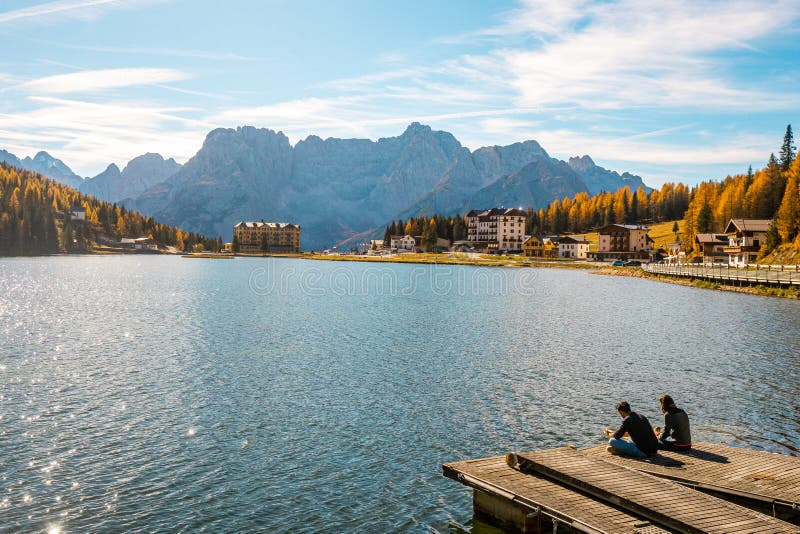 Casal com vista do lago Misurina ou Lago Misurina e paisagem natural em Dolomites antes do pôr do sol no outono, Dolomites fotos de stock royalty free Casal com vista do lago Misurina ou Lago Misurina e paisagem natural em Dolomites antes do pôr do sol no outono, Dolomites fotos de stock royalty free